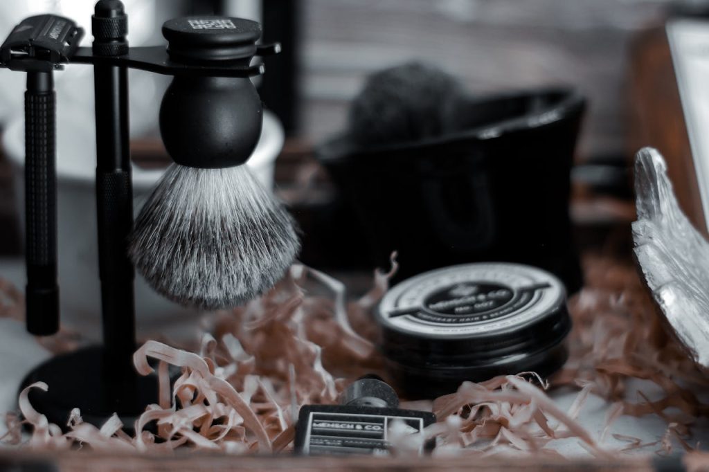 Collection of classic shaving tools in a modern barbershop setting with a focus on a shave brush.